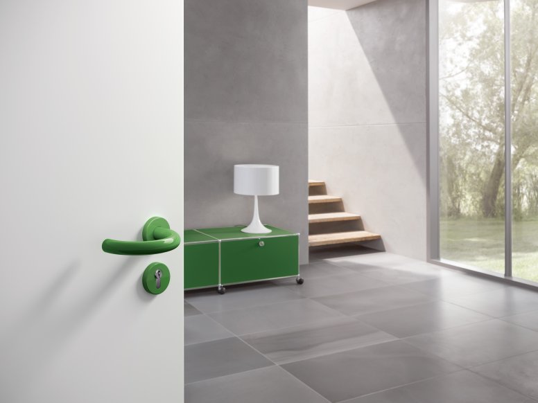 Lever handle with curved U-shape in the colour may green made of polyamide